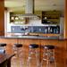 The Elerts renovated the kitchen by removing the upper cabinets, creating a more open layout to the dining area. They kept the original cabinets, created a snack bar and upgraded the countertops. Melanie Maxwell | AnnArbor.com